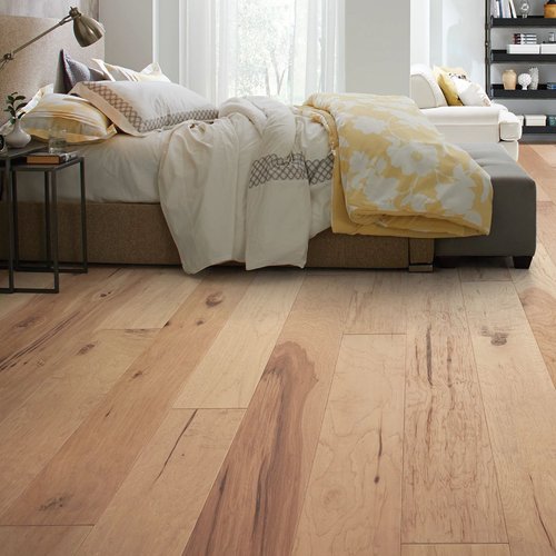 A bedroom interior with hardwood floors