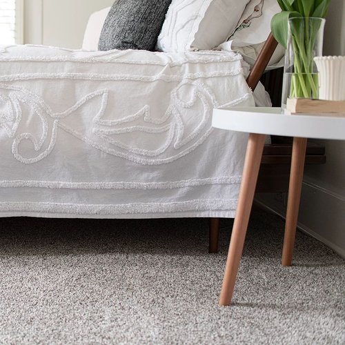 A carpeted bedroom interior