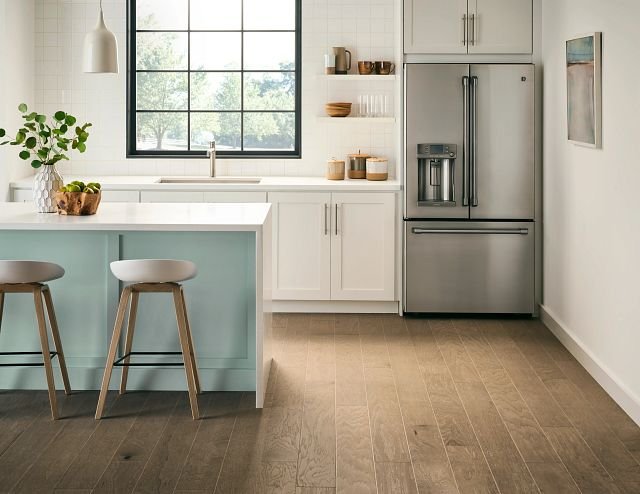 modern open kitchen with white cabinets and bar top